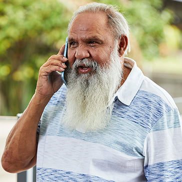 Male carer on the phone to Carer Gateway